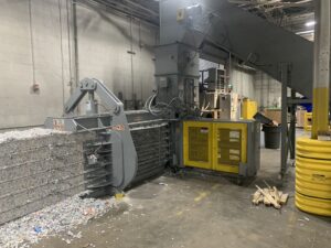 American 5029H9T30-4 baler baling shredded paper into bales