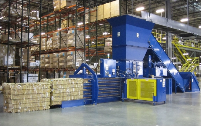 Auto-tie baler producing dense cardboard bales in a warehouse